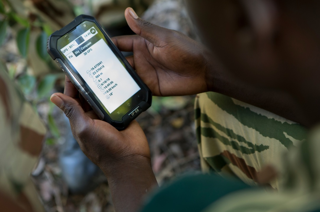 Ranger consulting a tactical GPS in the field